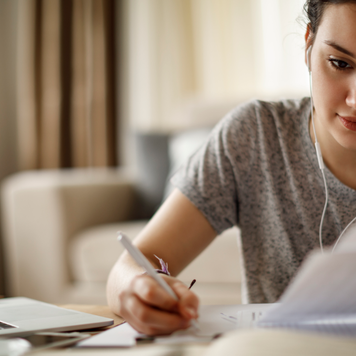 Woman at a desk writing financial payment plan