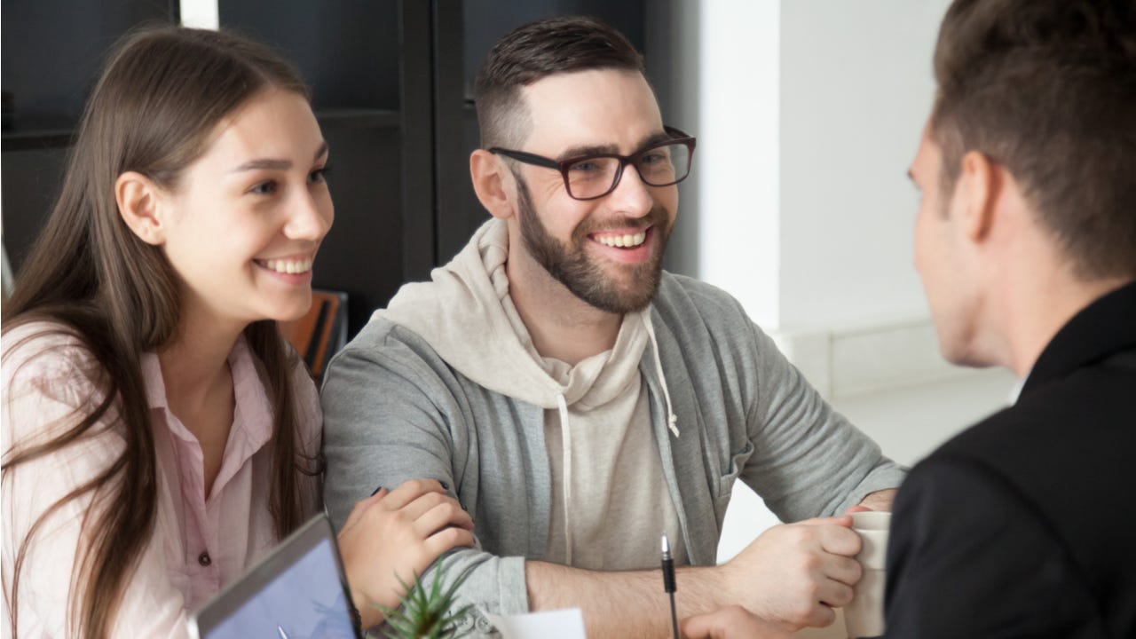 Man and woman talk with a banker