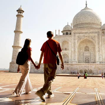 Young couple walking in the Taj Mahal courtyard