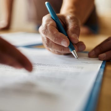 Close up of a person signing a contract