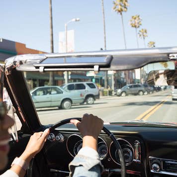 Woman driving a convertible with the top down