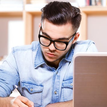 Young man works on paying bills
