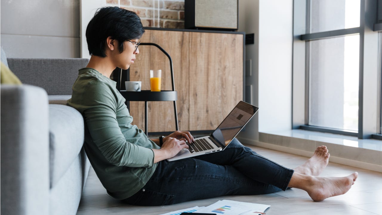 Man checks finances on laptop
