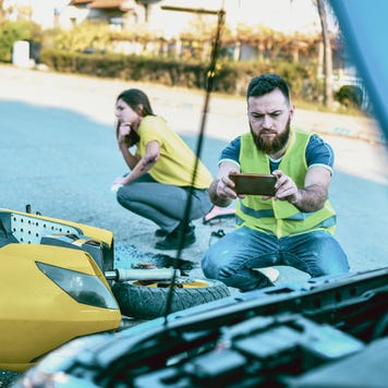 A consultant takes a photo of the aftermath from an accident with his smartphone.