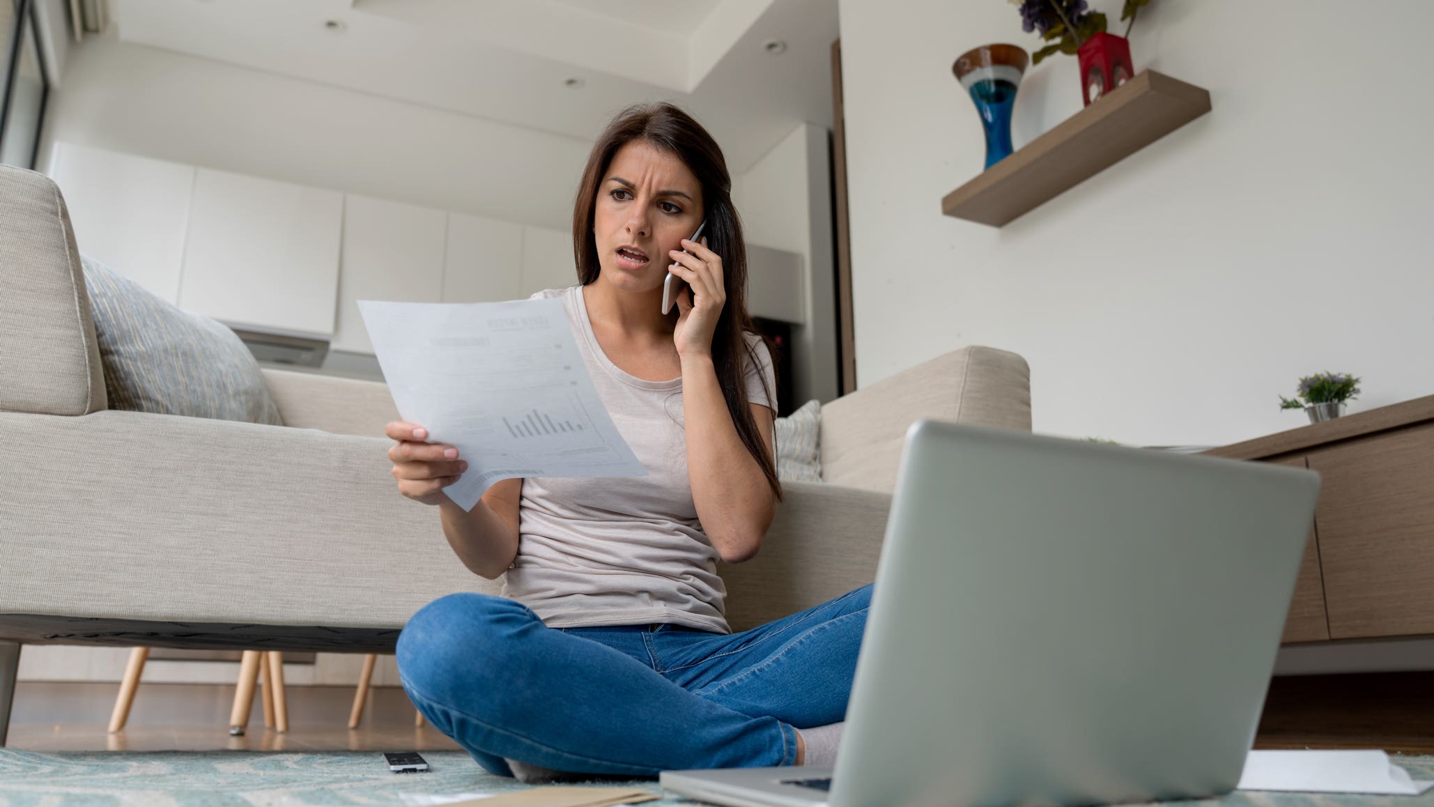 Woman at home complaining about on the phone