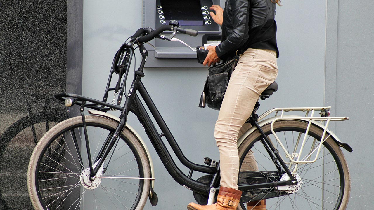 Woman at atm on bike