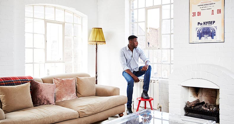 Man leaning against windowsill | Kelvin Murray/Getty Images