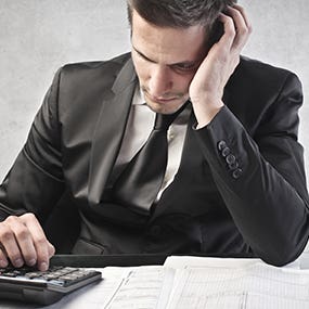 Man worried calculating tax return © olly - Fotolia.com