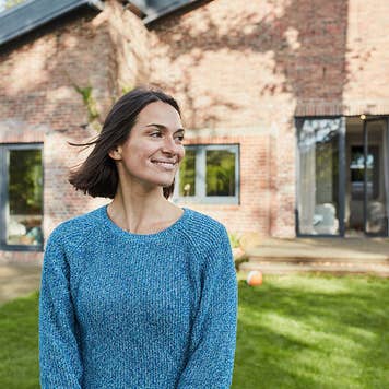 Woman standing in front of house