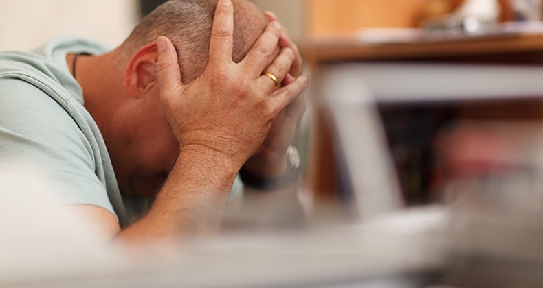 Man with head in hands © d13/Shutterstock.com