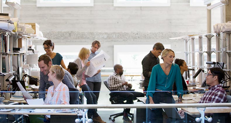 Co-workers busy in office | Compassionate Eye Foundation/Hero Images/Getty Images
