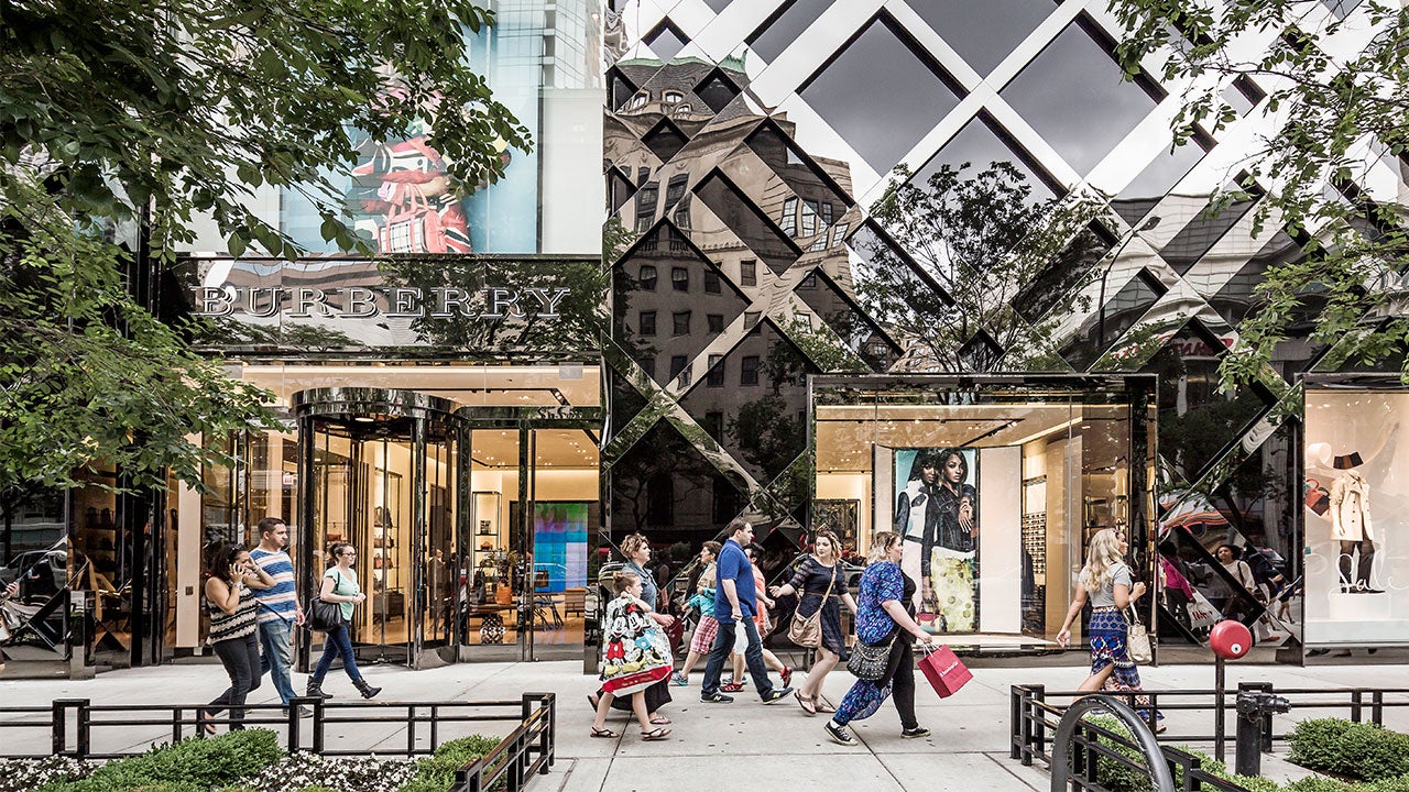 American consumers walking by shopping center