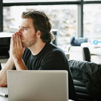 Person folds his hands in front of their face