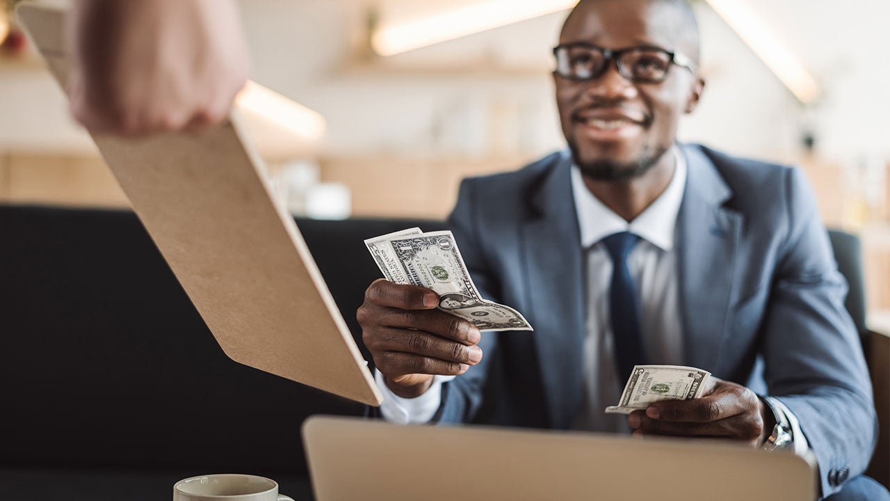Man paying bill with cash
