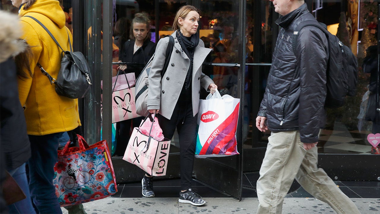 Christmas shopping leave store with shopping bags