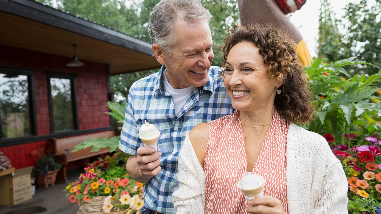 Middle aged couple eating ice cream