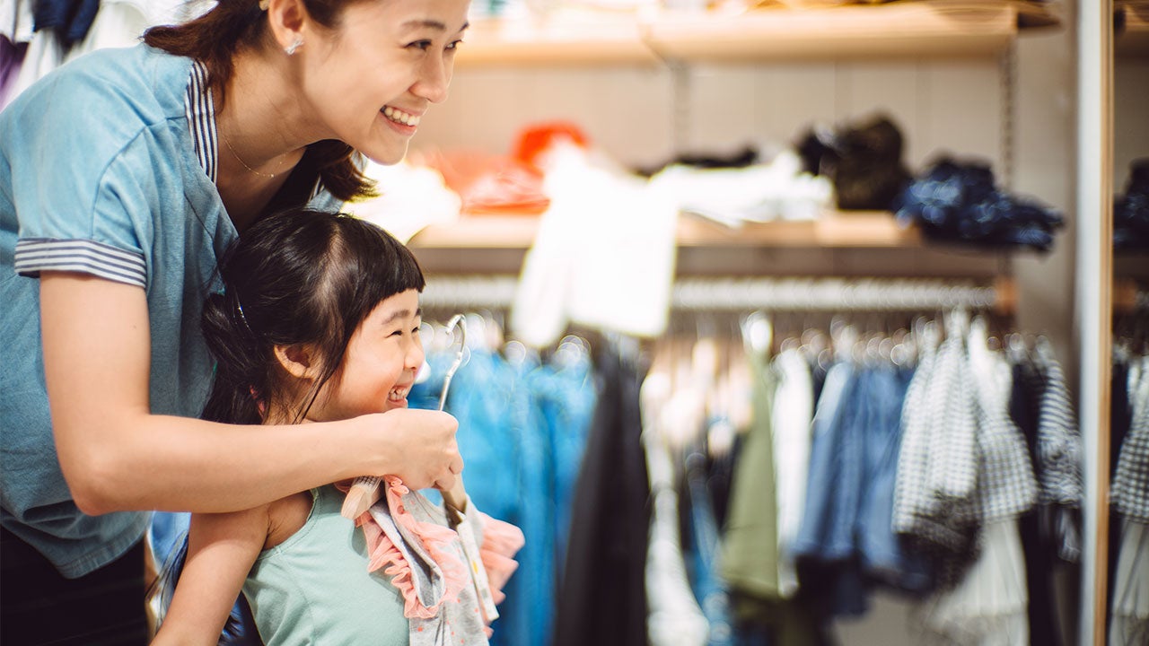 Mother and daughter clothing shopping