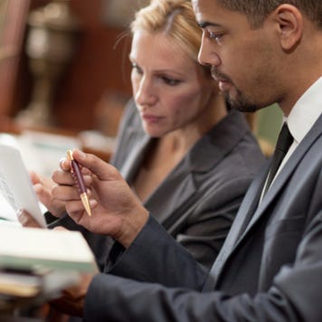 Lawyers examine paperwork together
