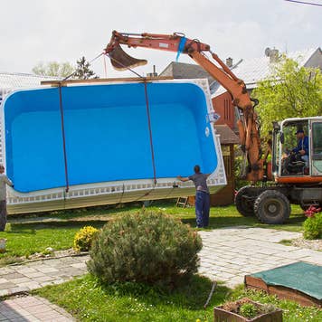 Forklift installing a swimming pool