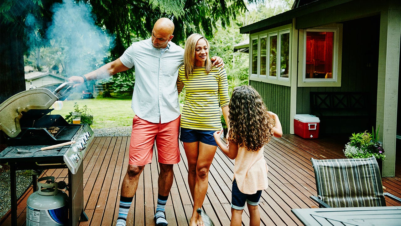 Family grilling on deck