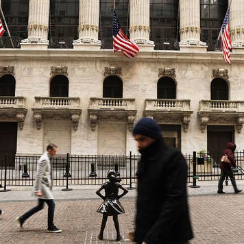 Pedestrians walking past the New York Stock Exchange