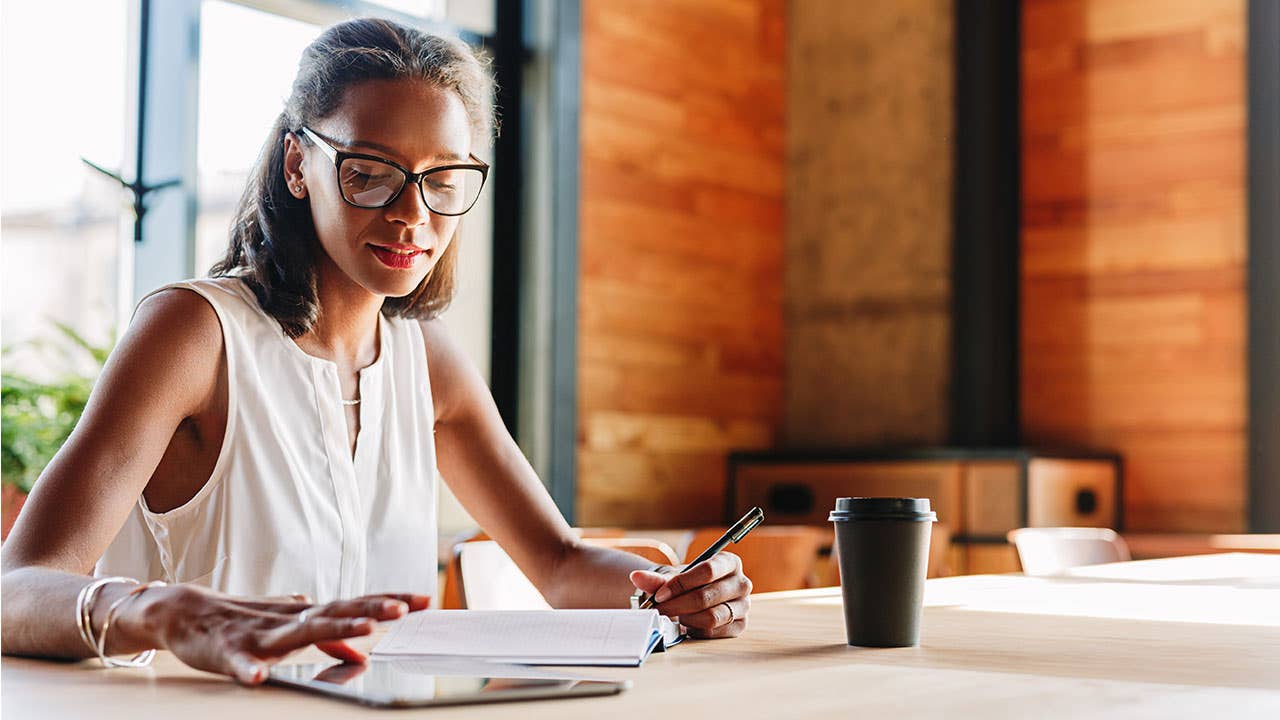 Woman using tablet for investing money