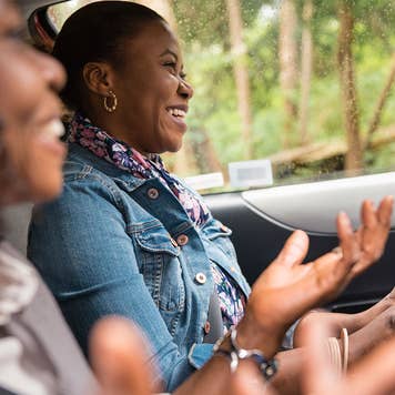 Mother and daughter driving in car