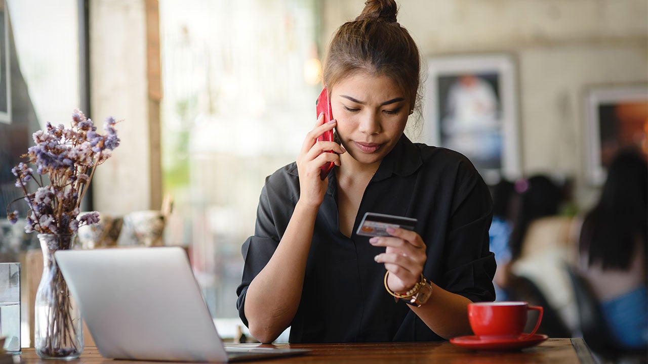 Woman on phone with credit card company