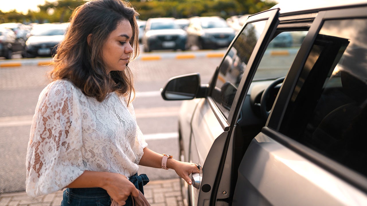 young woman getting into an SUV