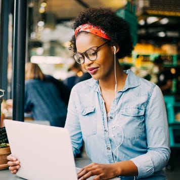 A young woman works on her laptop.