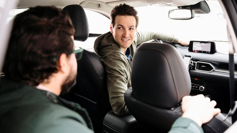 male driver talking to passenger