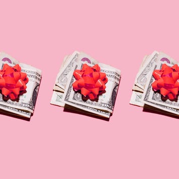 Row of folded dollar bills with red gift bows