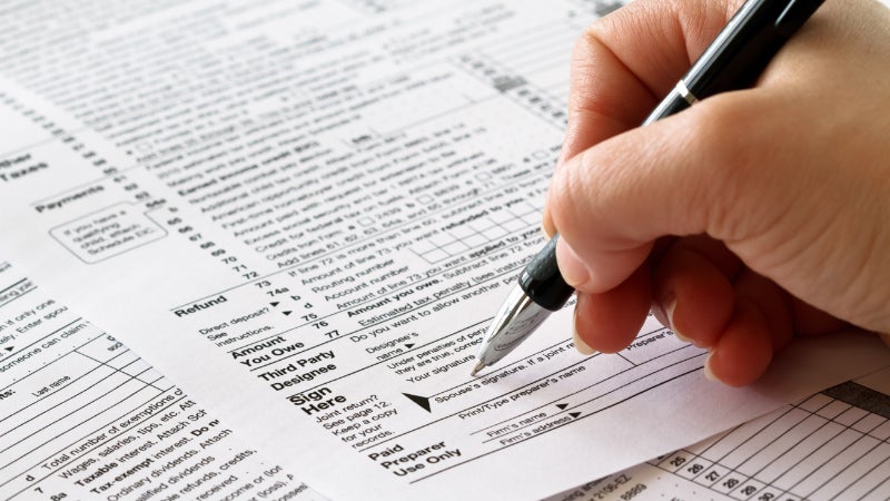 woman signing tax returns