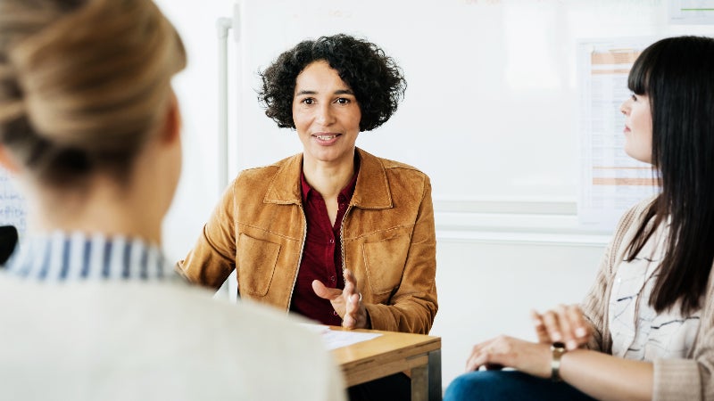 woman at table speaking