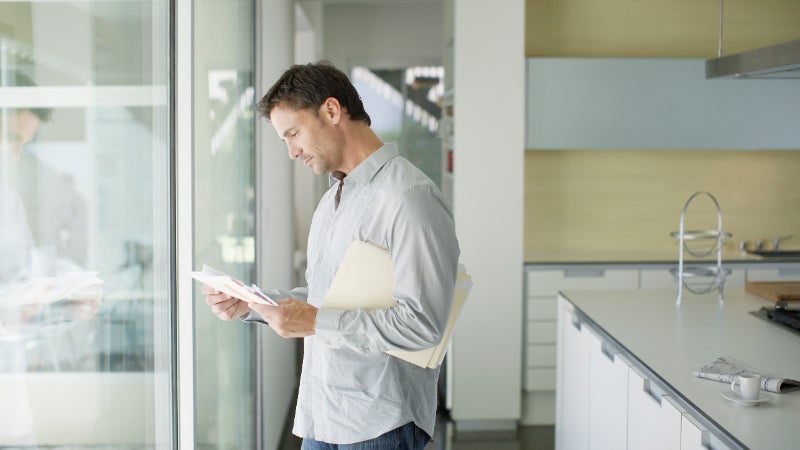 A white man reading a piece of paper.