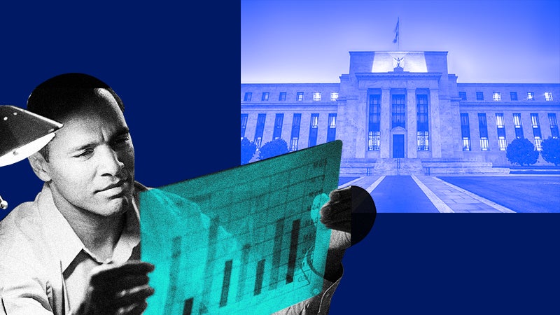 Man looking at bar graph amid Federal Reserve Eccles Building