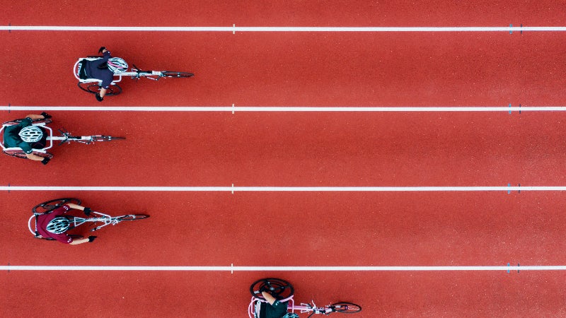 A photo of paracylcists racing along a track