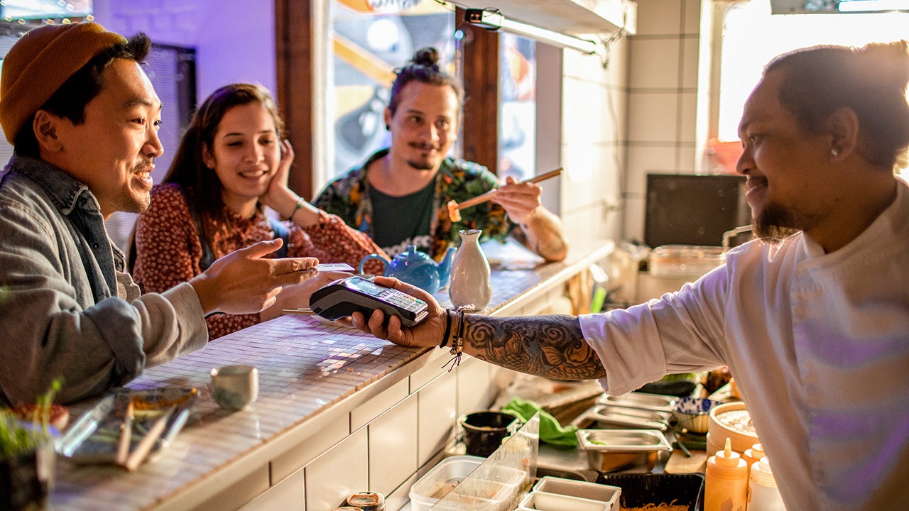 Small group of friends enjoying sushi at the local sushi bar