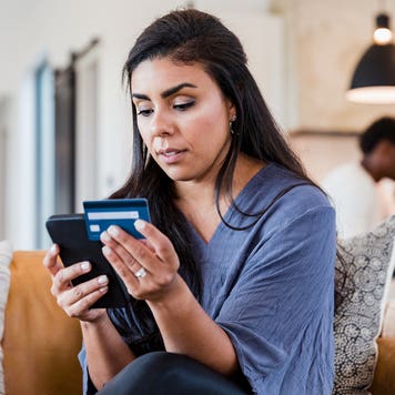 woman using credit card and smartphone