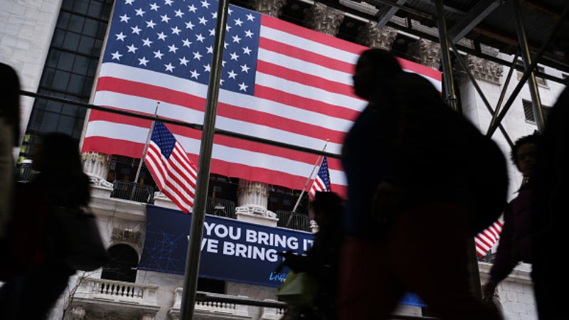 People walk outside the New York Stock Exchange