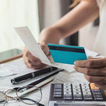 someone holding a receipt and card in hand