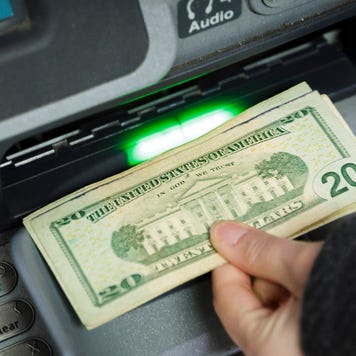 A customer withdraws cash from an ATM.