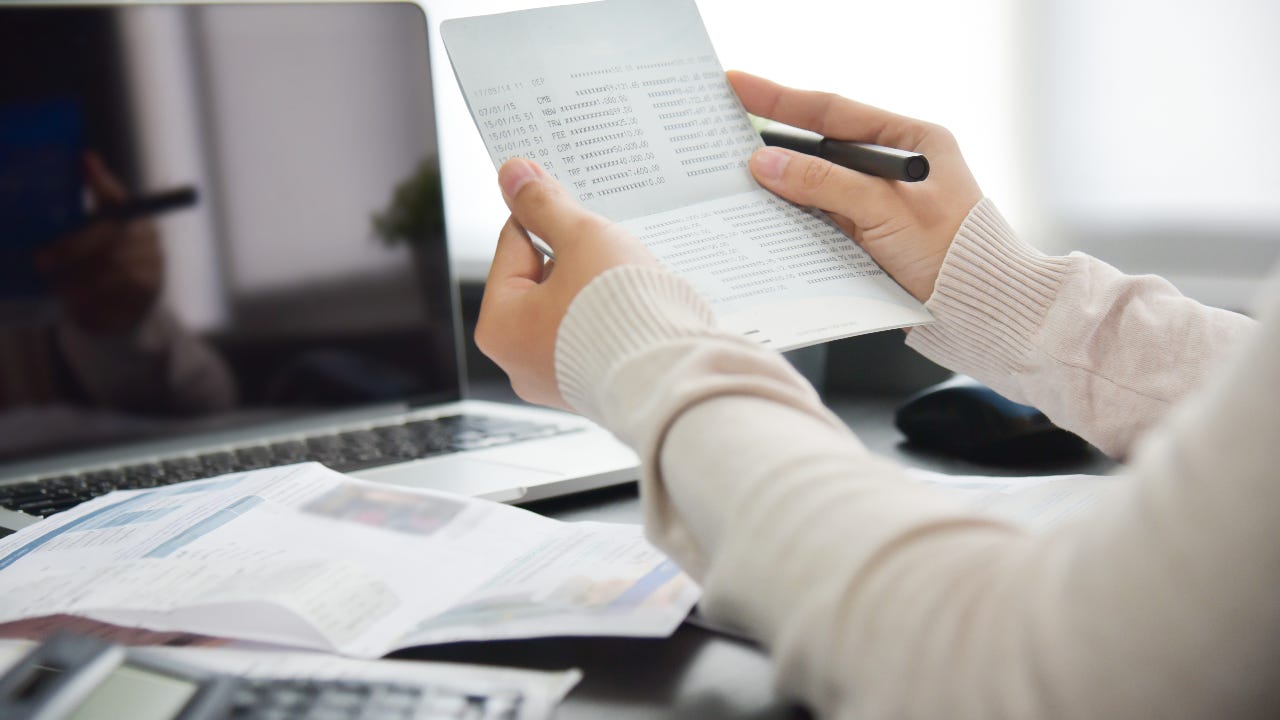 A person is in their home office calculating their taxes