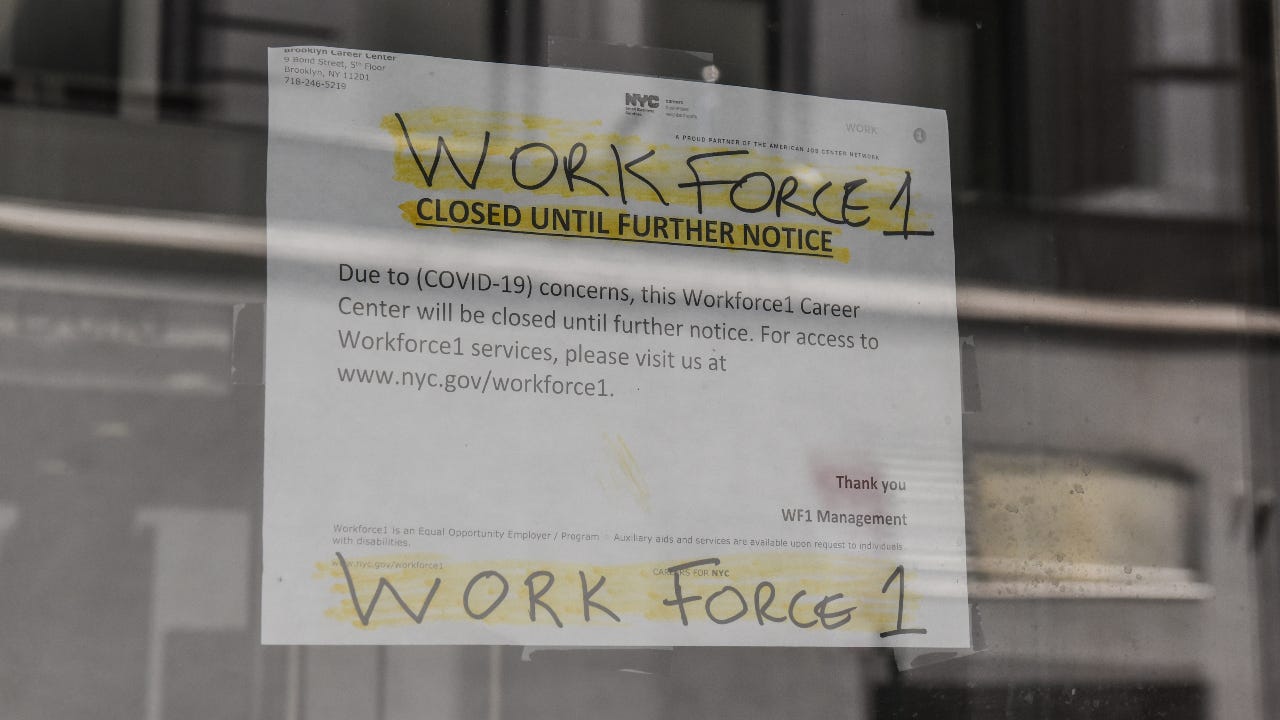 A sign stating that job placement program is closed during coronavirus pandemic.