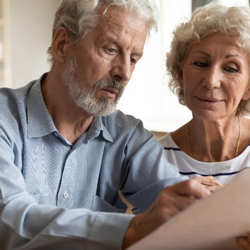 An older couple reviews a bill.