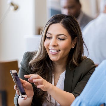 A bank representative helps a customer with buying a home.
