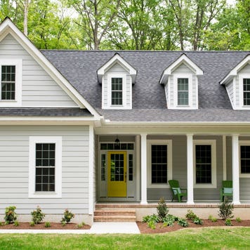 An exterior of a home with landscaped yard