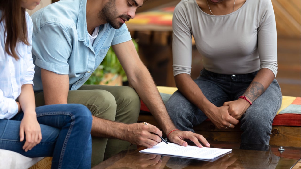 Borrowers meet with a loan officer to refinance their mortgage.