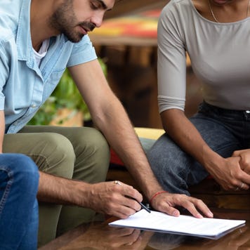 Borrowers meet with a loan officer to refinance their mortgage.