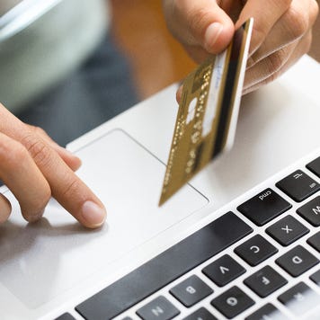Person on laptop with credit card
